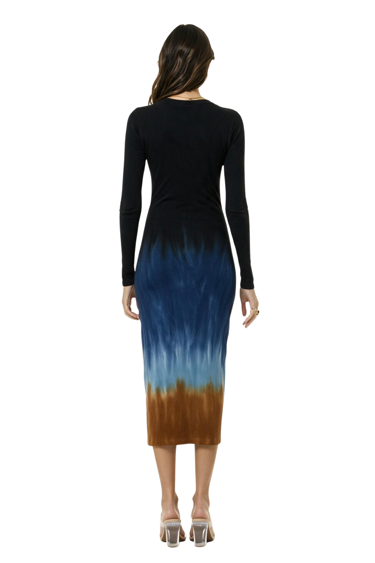 A woman viewed from the back wearing a long-sleeve midi dress with a navy upper section and a blue-to-brown gradient lower section, paired with clear high-heeled sandals on a white background.