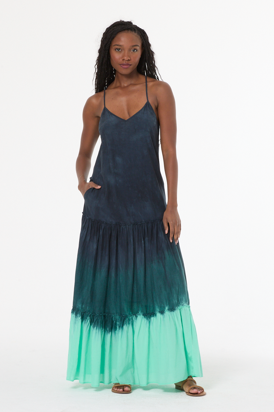 Woman wearing a green and blue gradient dress on a white background
