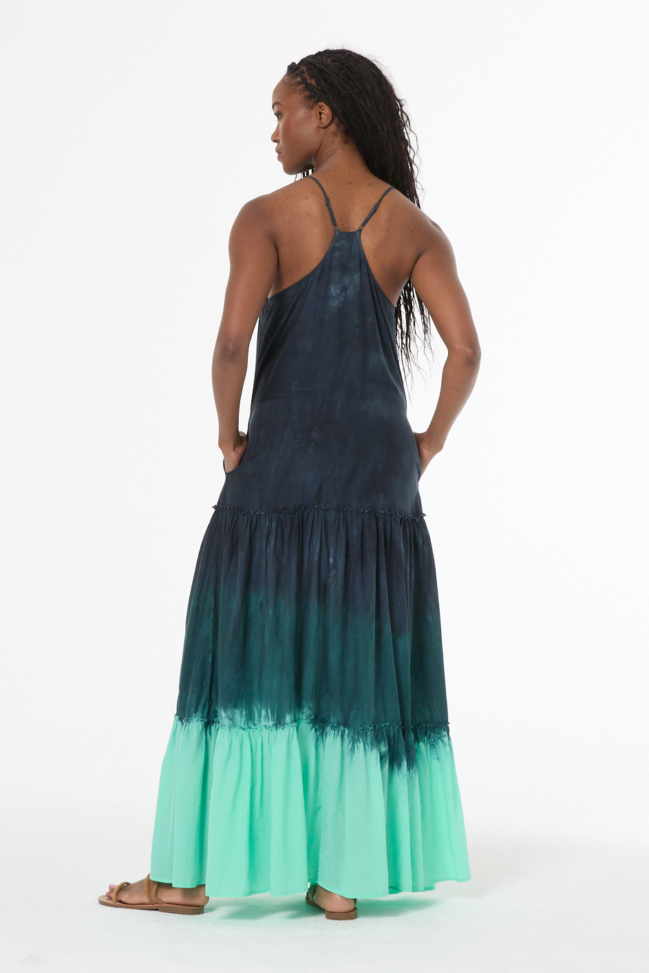 Woman wearing a black and green gradient dress on a white background