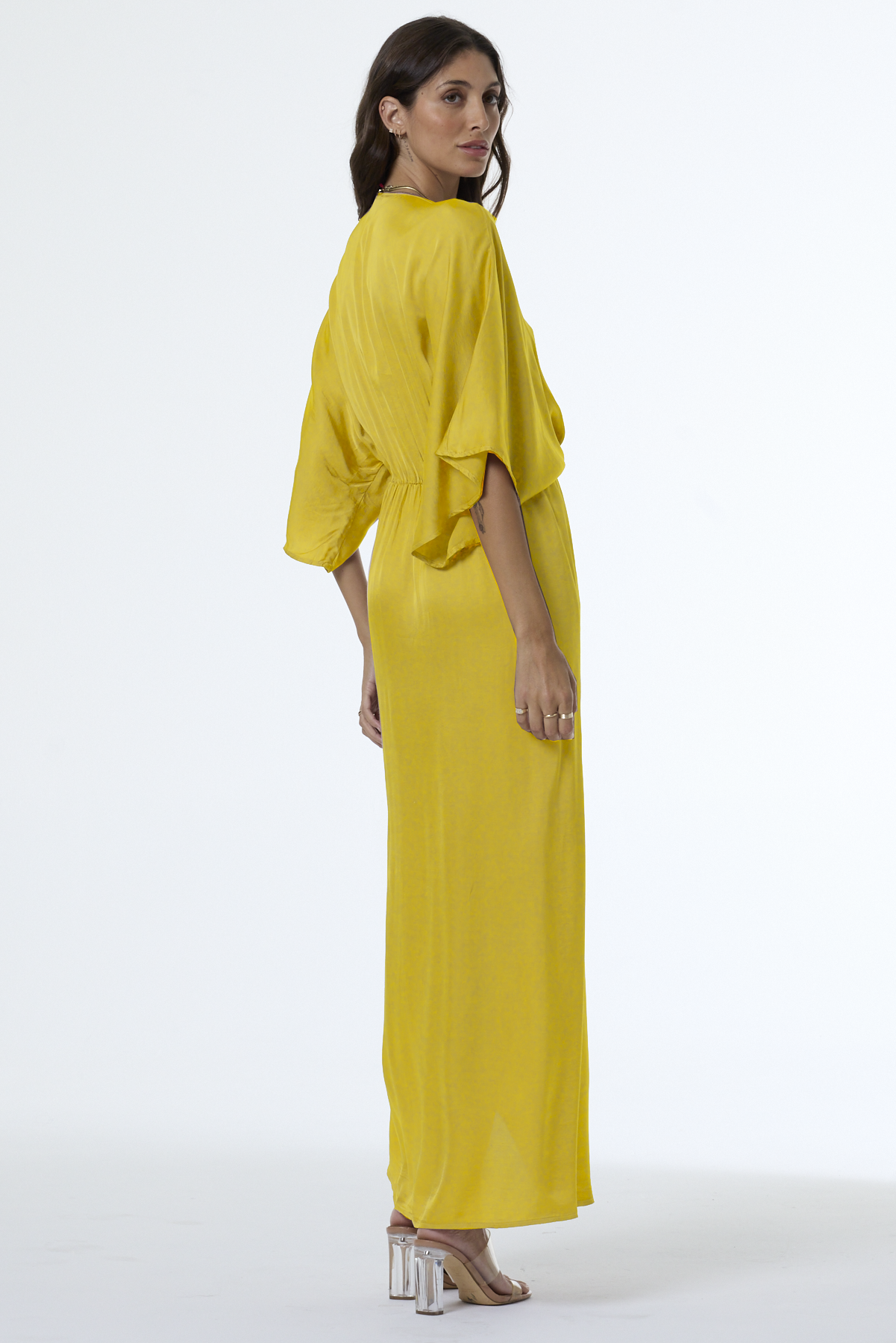 Woman wearing a yellow dress on a white background