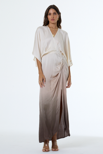 Woman wearing a beige draped dress on a white background
