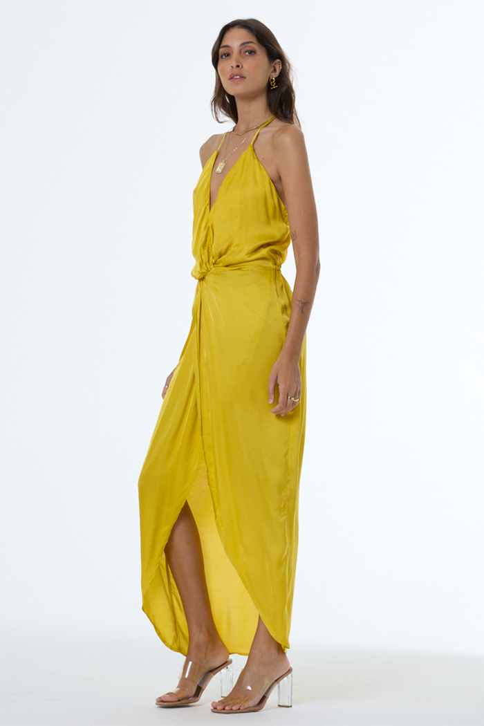 Woman wearing a yellow dress on a white background