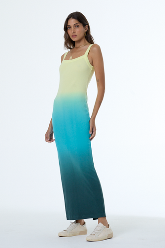 Woman wearing a gradient dress with yellow to blue color transition on a white background
