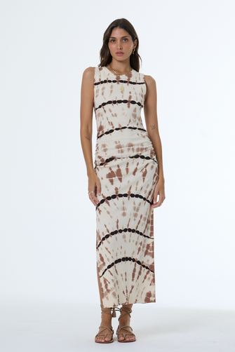 Woman wearing a sleeveless dress with tie-dye pattern on a white background