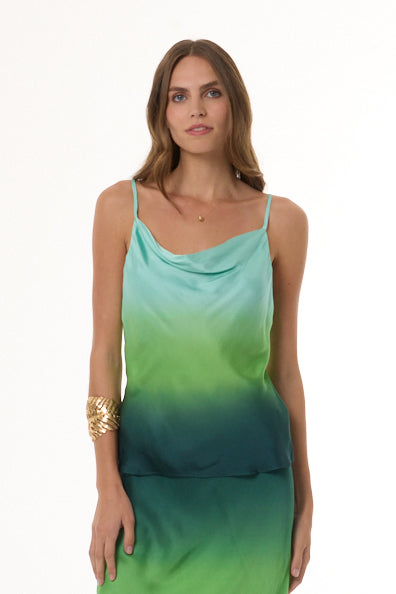 A woman modeling a sleeveless cowl-neck cami and matching skirt with a gradient color transition from light aqua at the top to bright green and deep teal at the bottom, set against a plain white background.