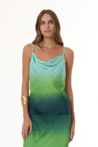 Woman wearing a green gradient top on a white background