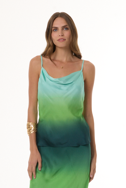 Woman wearing a green gradient top on a white background
