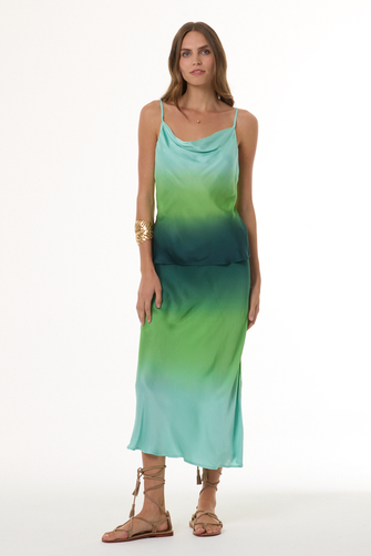 Woman wearing a gradient cami and skirt set with green and blue colors on a white background