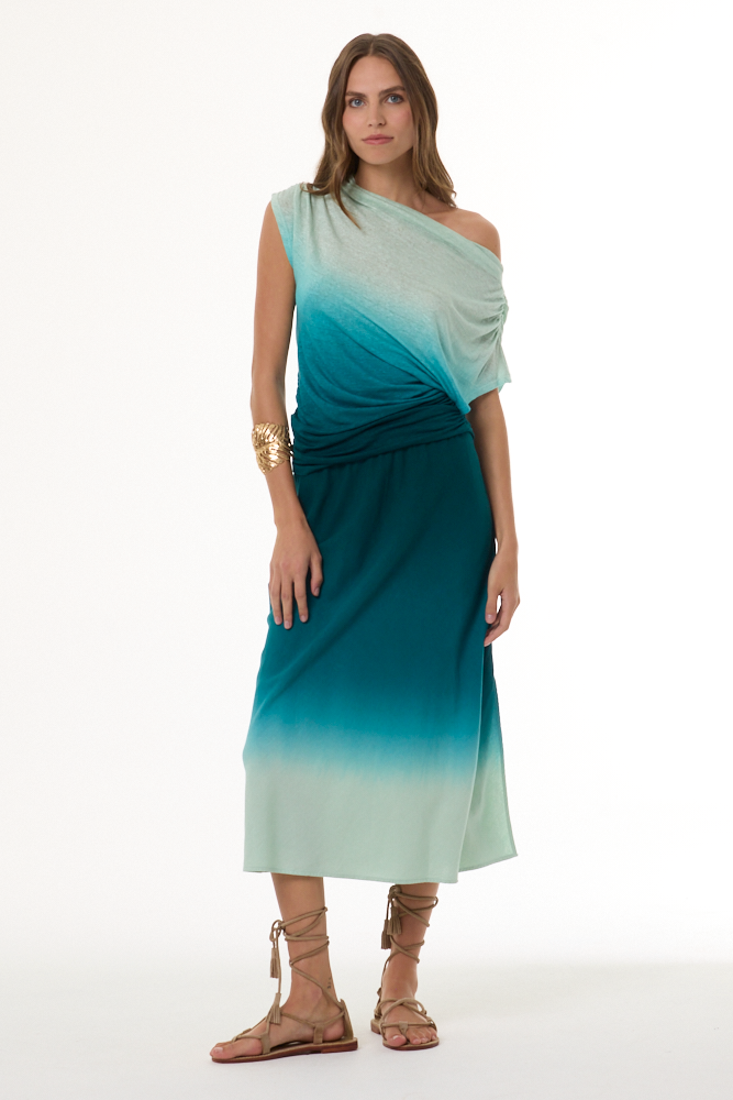 Woman wearing a gradient off the shoulder top and matching skirt with green and blue colors on a white background