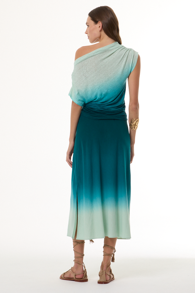 Woman wearing a gradient off the shoulder top and matching skirt with green and blue colors on a white background