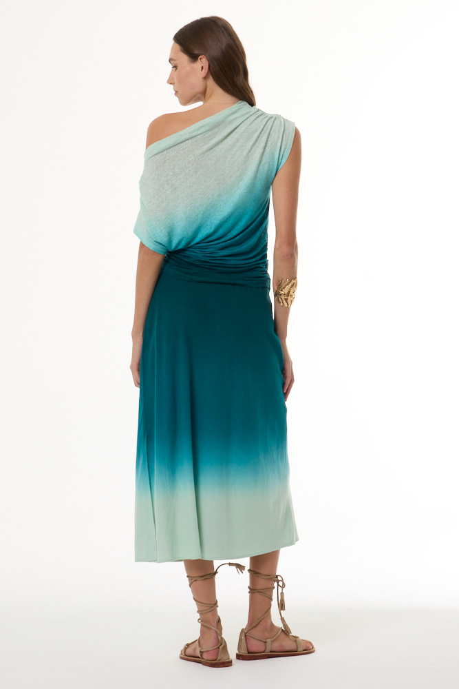 Woman wearing a gradient dress with one shoulder, standing against a white background