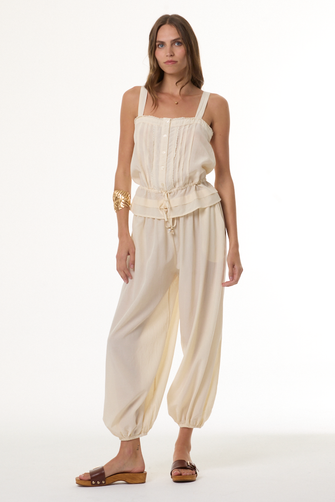Woman wearing a beige outfit on a white background