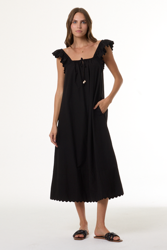 Woman wearing a black dress with ruffled shoulders on a white background
