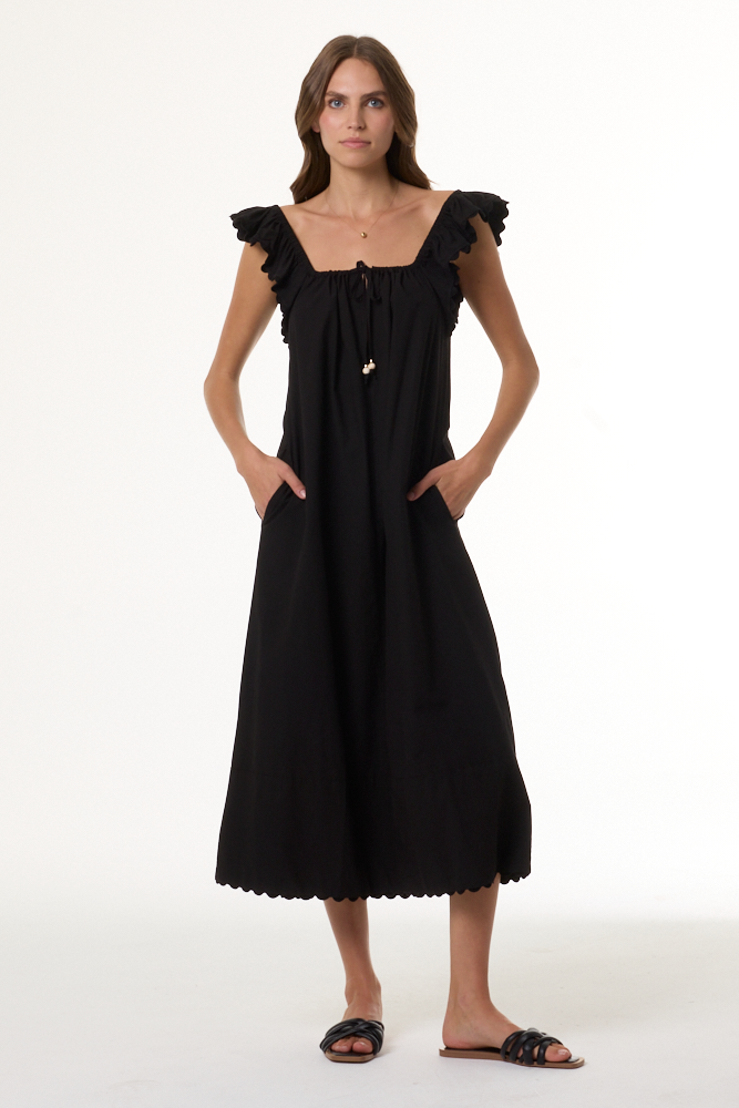 Woman wearing a black dress with ruffled shoulders on a white background