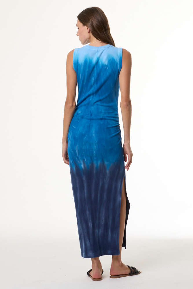 Woman wearing a blue tie-dye dress on a white background