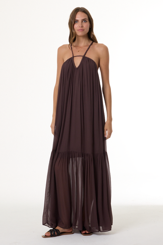 Woman wearing a long brown dress on a white background