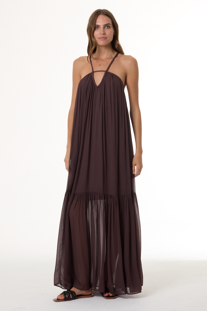 Woman wearing a long brown dress on a white background