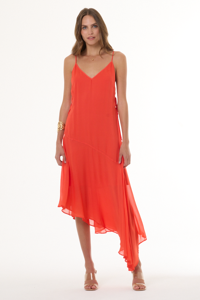 Woman wearing a coral dress on a white background