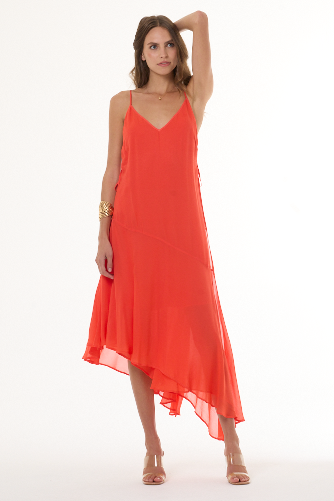 Woman wearing a coral dress on a white background