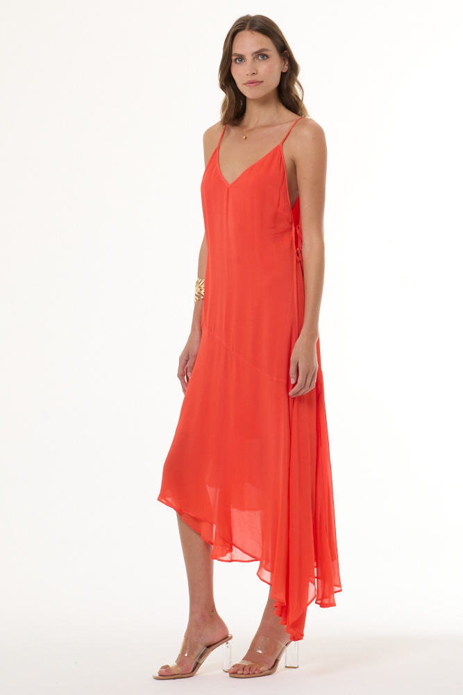 Woman wearing a coral dress on a white background