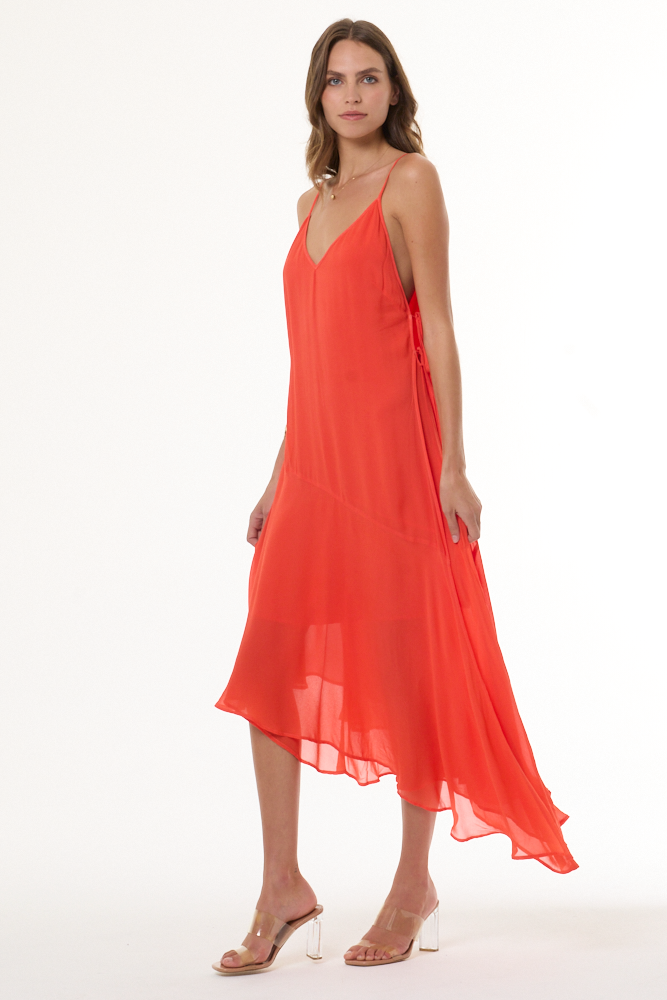 Woman wearing a coral dress on a white background