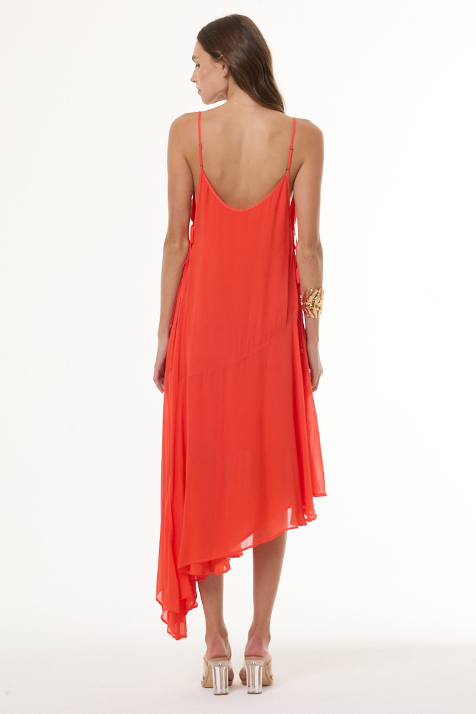 Woman wearing a coral dress on a white background
