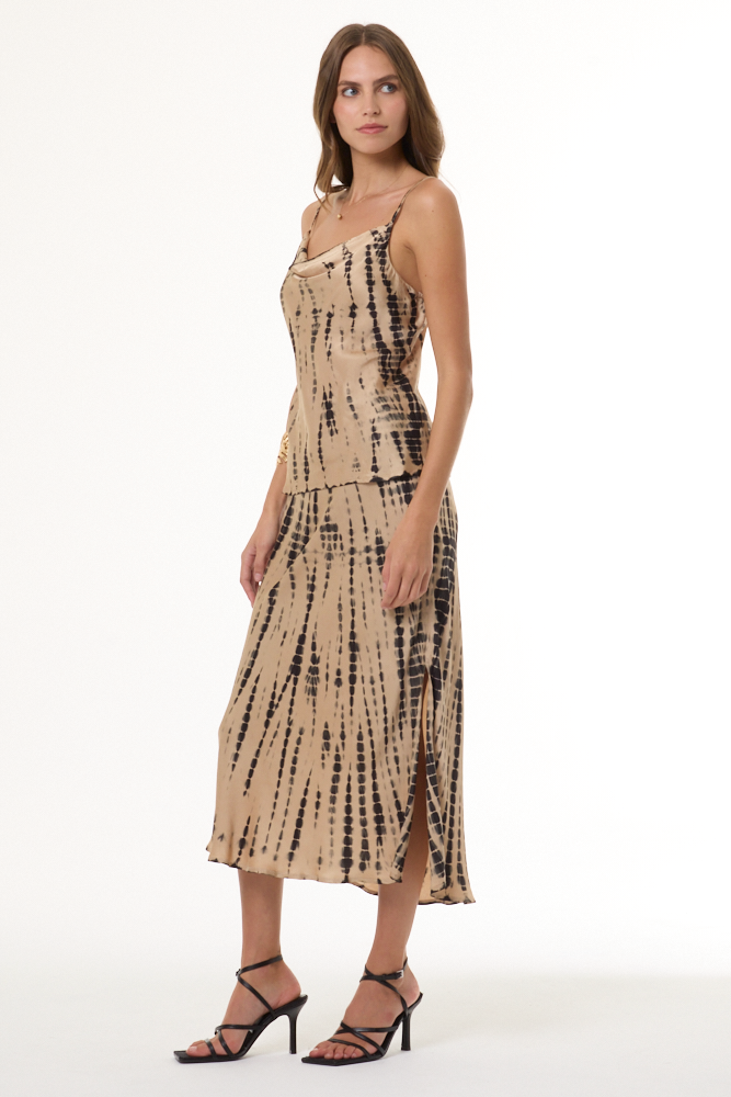 Woman wearing a beige and black tie-dye cami and skirt set on a white background