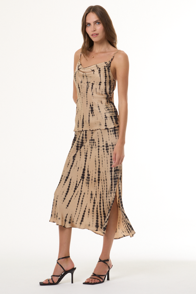 Woman wearing a beige and black tie-dye cami and skirt set on a white background