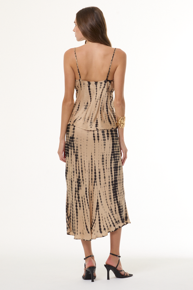Woman wearing a beige and black tie-dye cami and skirt set on a white background