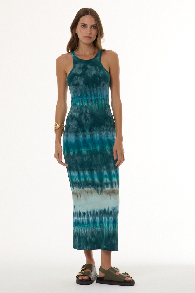 Woman wearing a turquoise tie-dye dress on a white background