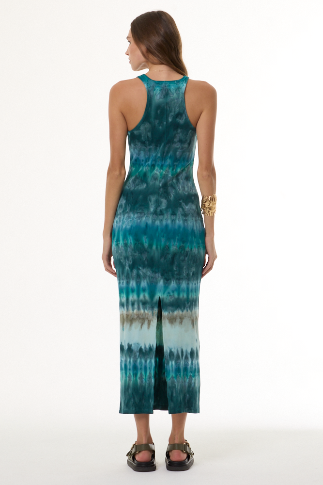 Woman wearing a turquoise tie-dye dress on a white background
