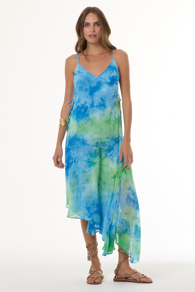 Woman wearing a blue and green tie-dye dress on a white background