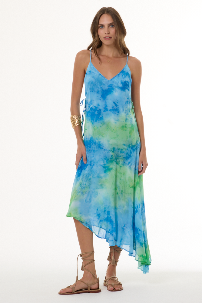 Woman wearing a blue and green tie-dye dress on a white background