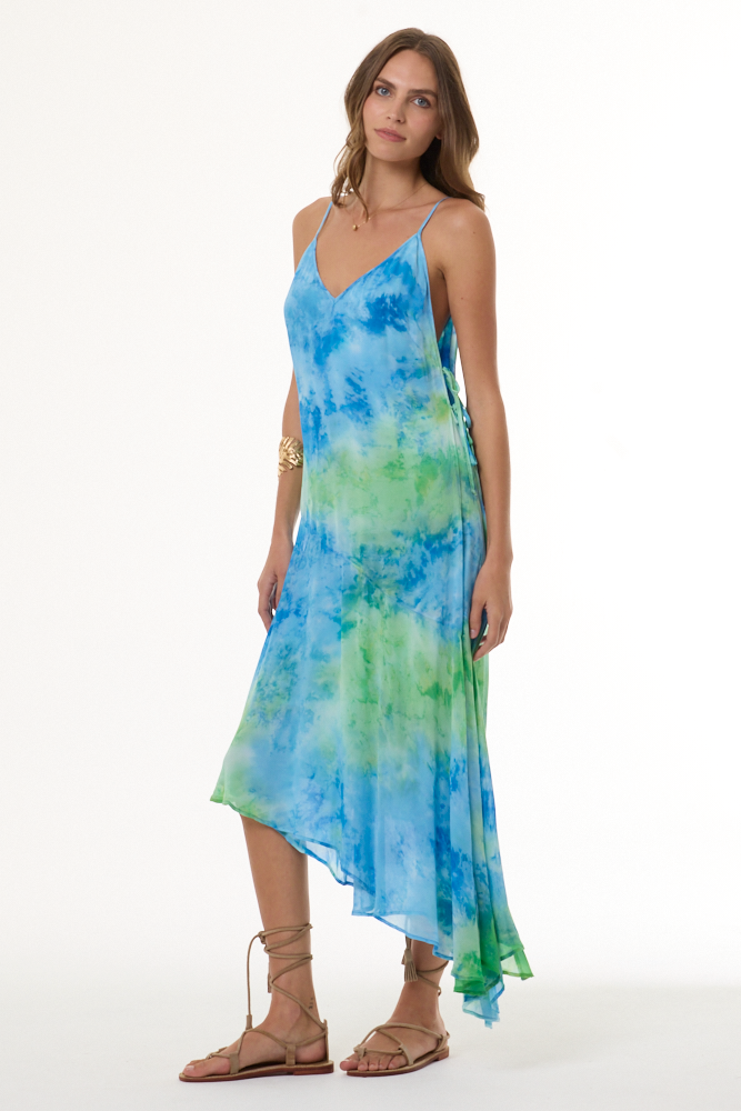 Woman wearing a blue and green tie-dye dress on a white background