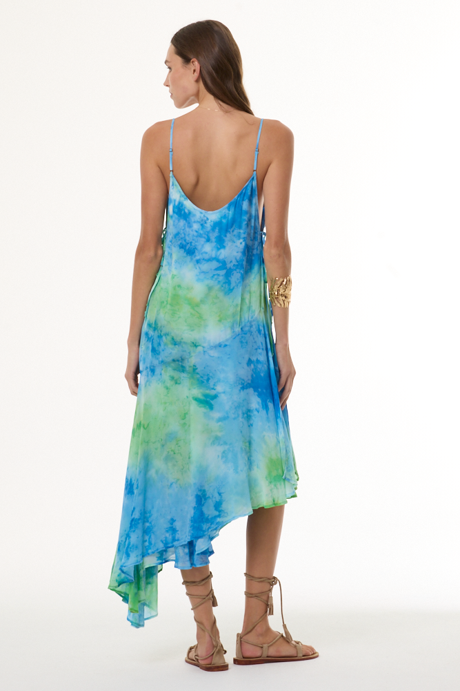 Woman wearing a blue and green tie-dye dress on a white background
