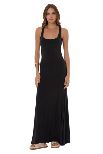 A woman modeling a sleeveless black maxi dress with a scoop neckline and halter-style straps, standing against a plain white background.