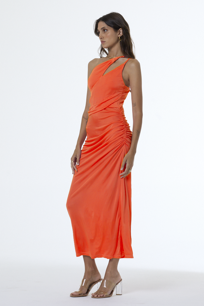 Woman wearing an orange one-shoulder dress on a white background