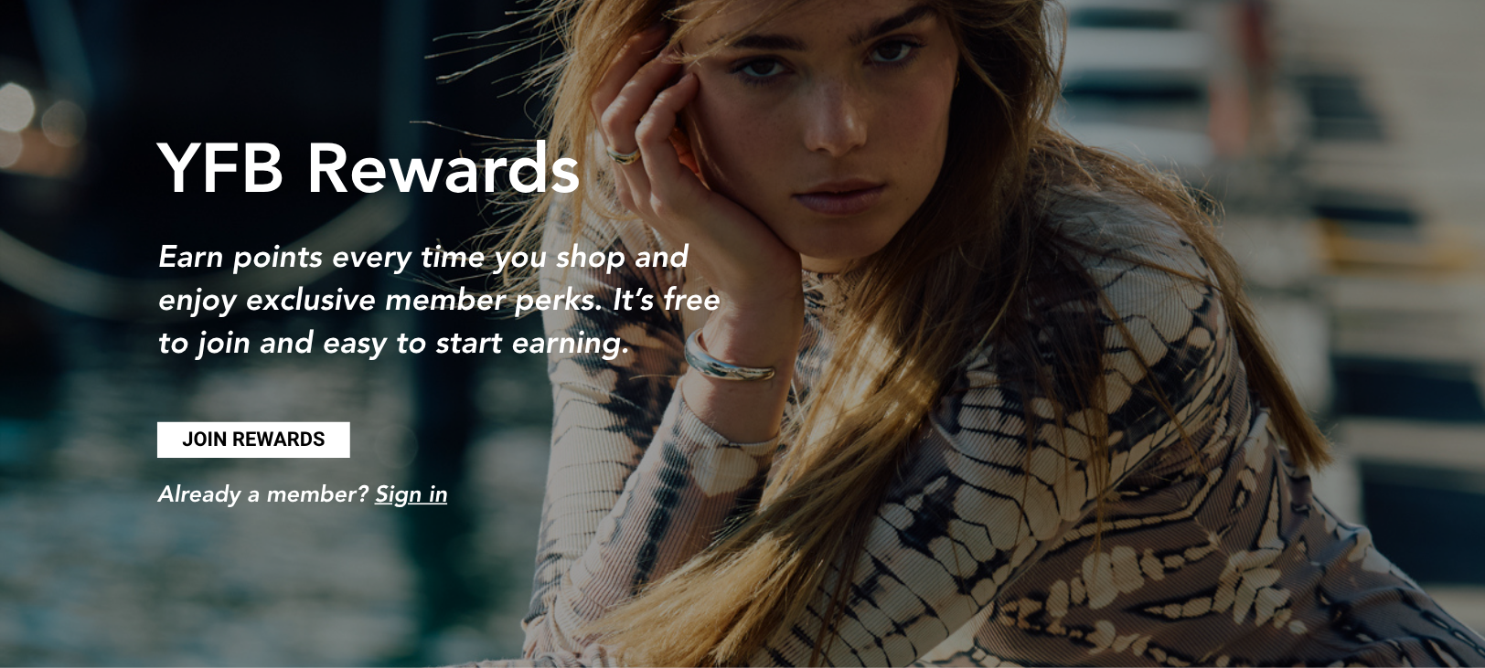 Image of a woman wearing a tie dye dress with text overlay "YFB Rewards- Join Now button"